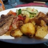Marinerad entrecôte med stekt potatis, bacon, paprika, brunsås och sallad.