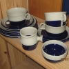 Tre koppar med fat och assietter samt sockerskål och kanna, design Marianne Westman för Rörstrand. Bild på stämpel finns i nästa bild.