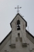 Kyrkans klocka på taket har en klockringning via rep ner till marken.